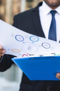 front-view-business-man-looking-charts-min front-view-business-man-looking-charts-min